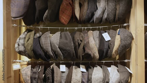 Large assortment of flat caps hanging on showcase in clothes shop photo