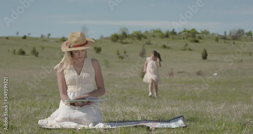 Young mother and her daughter enjoying in nature park - S LOG2 photo