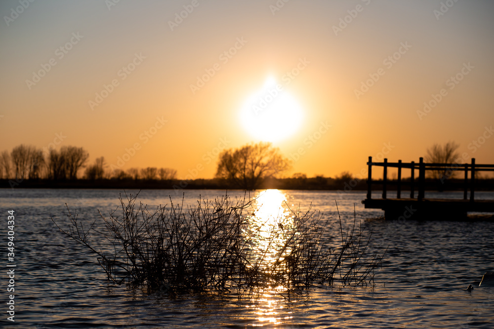 Naklejka premium sunset over the river
