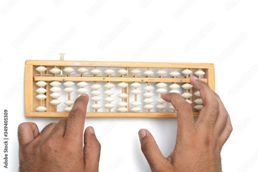 Close up hands are calculating using abacus over white background. Close up hands are calculating using abacus over white background.