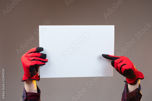 The person holds a white sh...
