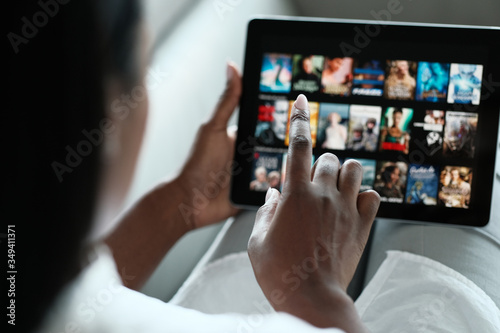 Fototapeta Black Woman Browsing Movie On Streaming Media Service