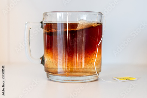 Cup with black tea in sachet