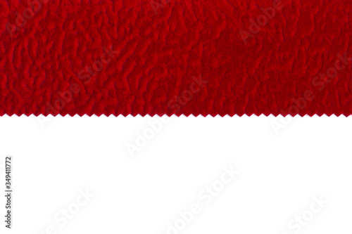 Cutted pattern of furniture shaggy fabric flock red color isolated on a white background in macro. Soft fleecy fabric for upholstery in red. Tissue industry.
