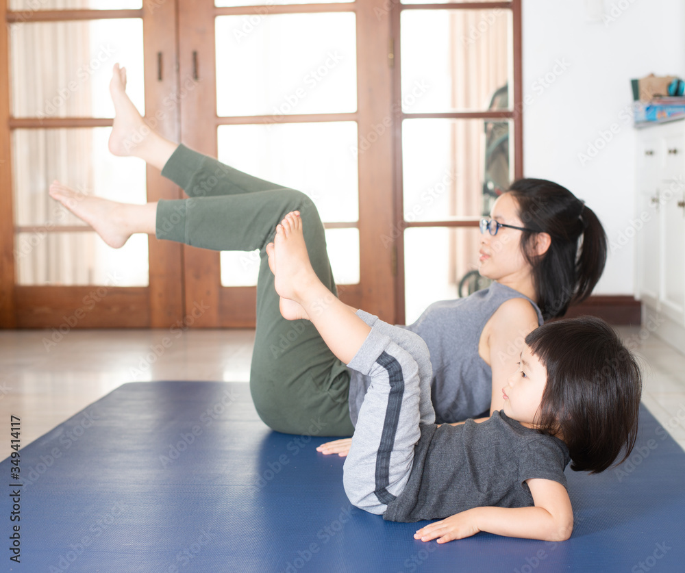 Asian girls and mothers are doing yoga by watching online yoga tutorial. Asian girls and mothers are doing yoga by watching online yoga tutorial.