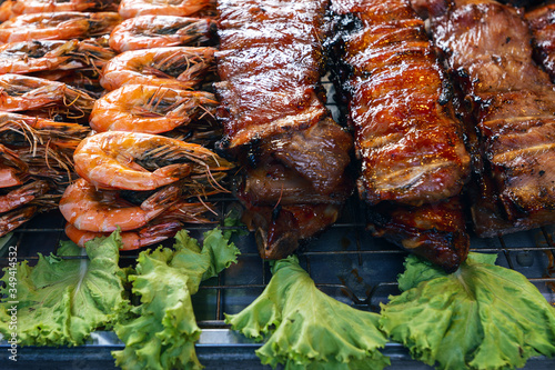 .Grilled and delicious seafood and meat arrangement on a counter in Thai restaurant. Barbecue srimps prawns. Thailand, Ko Pha Ngan photo