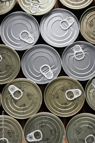 various tuna cans in gold and silver color from a top view