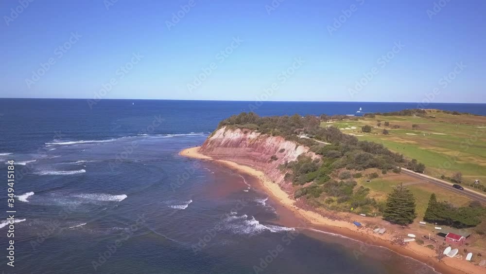 Aerial view of large golf field next to the blue ocean and coastal shore. Aerial view of large golf field next to the blue ocean and coastal shore.