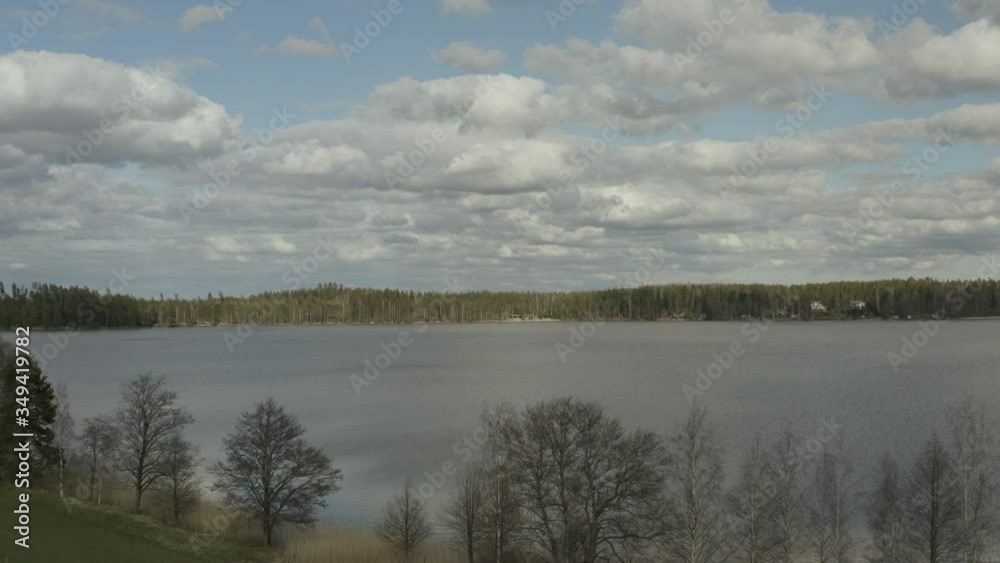 Flying around huge lake surrounded by forest and trees. Flying around huge lake surrounded by forest and trees.