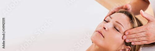 Woman undergoing acupuncture treatment