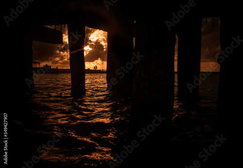 Sunset seen from under the pier in Isla mujeres Northern point beach