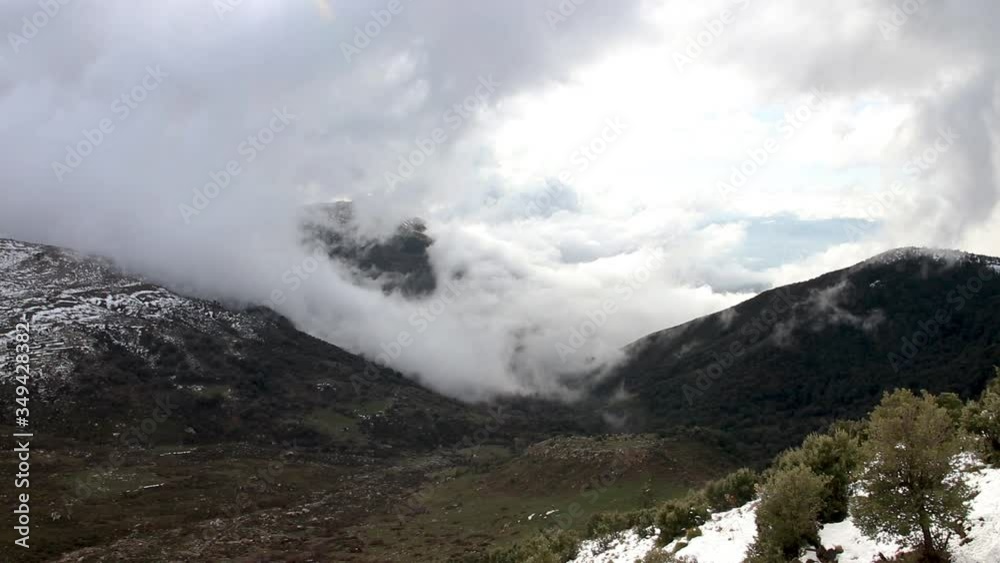 beautiful clouds covering a snowy mountain in Bouira north Algeria beautiful clouds covering a snowy mountain in Bouira north Algeria