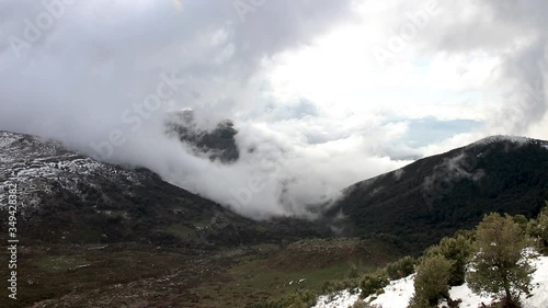 beautiful clouds covering a snowy mountain in Bouira north Algeria  photo