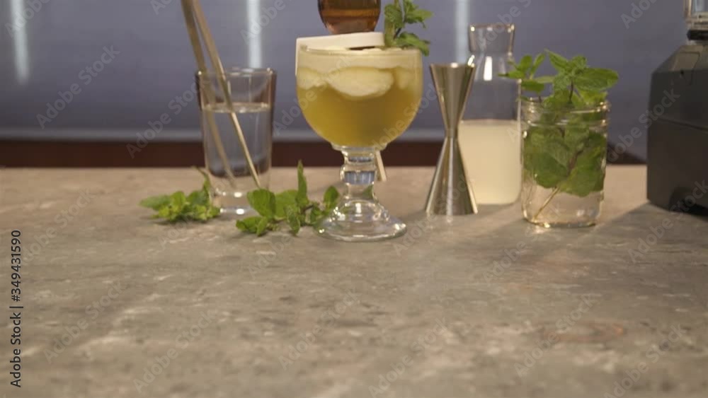 upright bottle with mint on drink on table - pedestal up