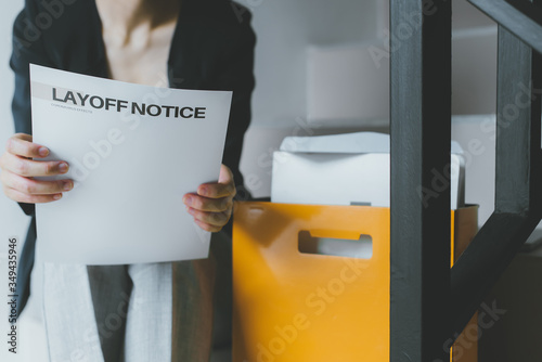 Female employee has stress and sadness after receiving a layoff notice. The impact of the economic recession during the Covid-19 (coronavirus) outbreak. photo