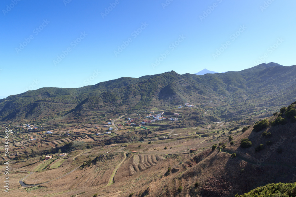 Naklejka premium Village panorama with volcano Mount Teide in the background on Canary Island Tenerife, Spain