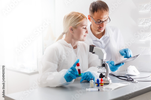 Young Female Scientist Analyzing Sample In Laboratory