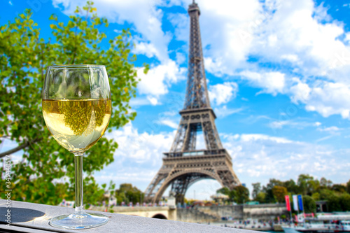 Fototapeta Glass of white wine with Eiffel tower view in Paris, France