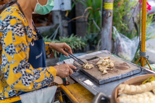 Fototapeta Naklejka Na Ścianę i Meble -  Thai Lady Prepares Tofu Vegetarian Street Food Snack