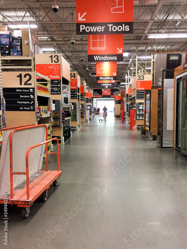 Aisle view at home improvement warehouse store with customers