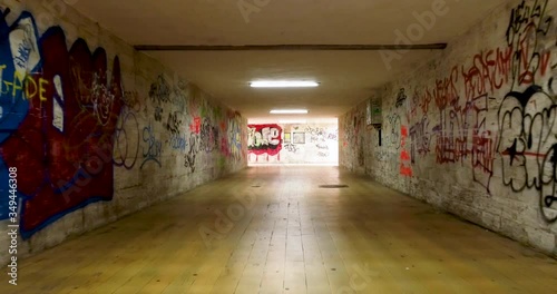 Underground pedestrian underpass with graffiti 