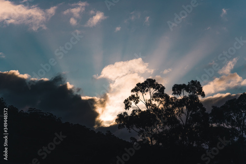 sunset with intense sunrays and beams of light over Kunanyi also know as Mount Wellington in Tasmania Australia