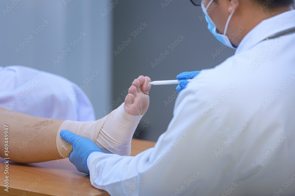 Feet holding with doctor,doctor analyzes and explains pain in the bones of the patient's feet.Doctor the traumatologist examines the leg examined at the medical office Feet holding with doctor,doctor analyzes and explains pain in the bones of the patient's feet.Doctor the traumatologist examines the leg examined at the medical office
