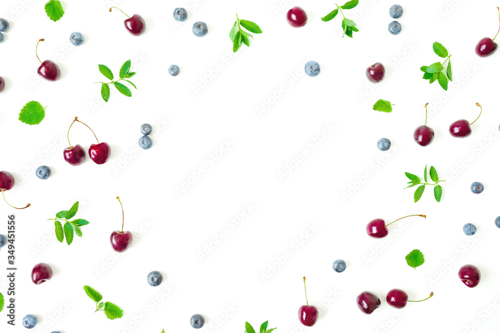Cherry and blueberries with mint leaves isolated on white background. Top view. Flat lay frame Cherry and blueberries with mint leaves isolated on white background. Top view. Flat lay frame