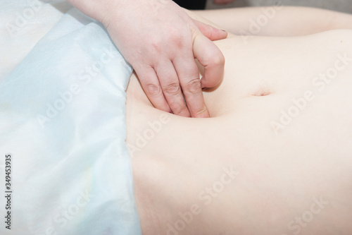 Human hands make massage on stomach. Healthcare