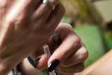 Medical syringe in female hands.