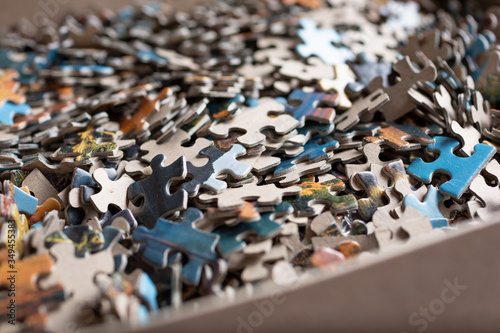 A view of jigsaw puzzle pieces in a box.