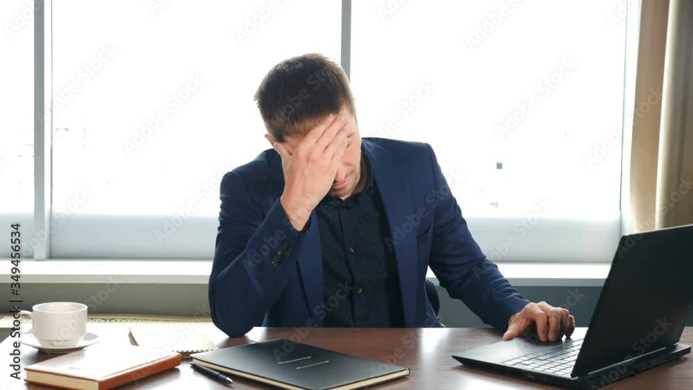 Depressed desperate man feeling worried about financial problem. Stressed businessman looking frustrated thinking of money debt, budget loss, bankruptcy sitting at home or in office. Worried business