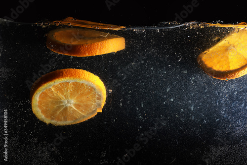 Water drops on ripe sweet orange. Fresh mandarin background with copy space for your text. Vegetarian concept. photo