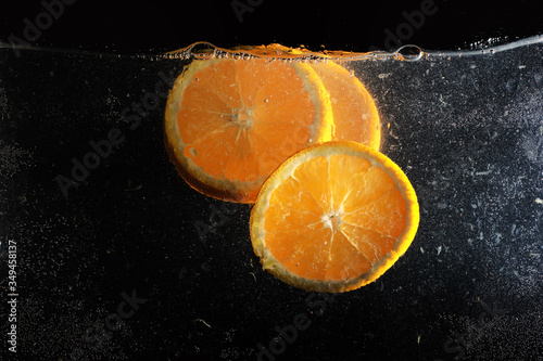 Water drops on ripe sweet orange. Fresh mandarin background with copy space for your text. Vegetarian concept. photo