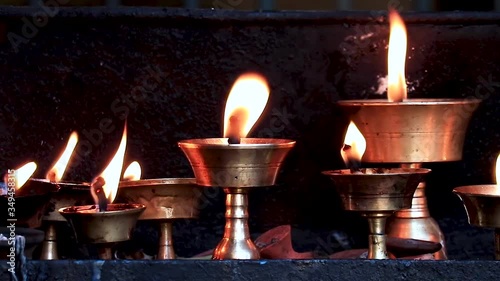 Close up of Traditional Butterlamps with fire at a monastery. slow motion video photo