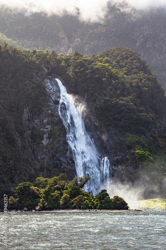 Fiordland National Park. Streams from the mountains. Waterfall on the background of a green mountain. New Zealand