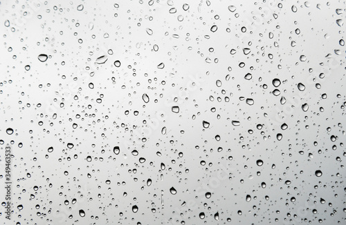 Raindrops on light window glass