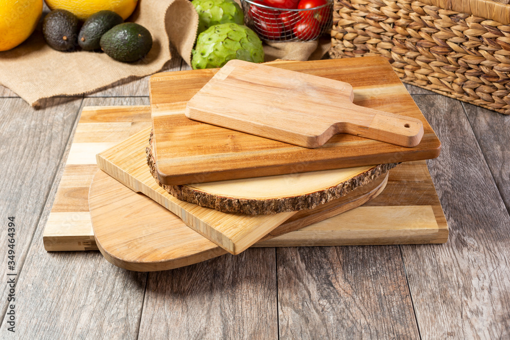 A view of a stack of several wooden cutting boards, in a still life setting. A view of a stack of several wooden cutting boards, in a still life setting.