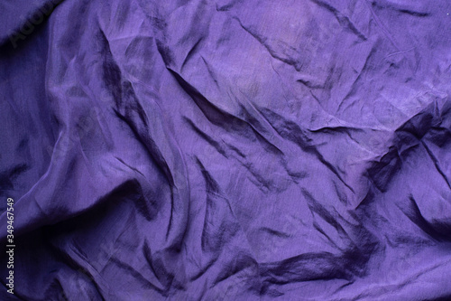 Violet background. The texture of the fabric. Drapery magenta