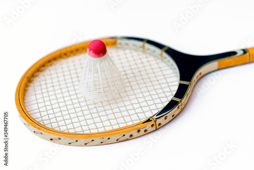 Close-up.Badminton concept.Racket and shuttlecock.Badminton racket and white shuttlecock with red cap on white background. © ARVD73
