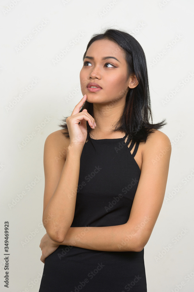 Portrait of young beautiful Asian businesswoman thinking Portrait of young beautiful Asian businesswoman thinking