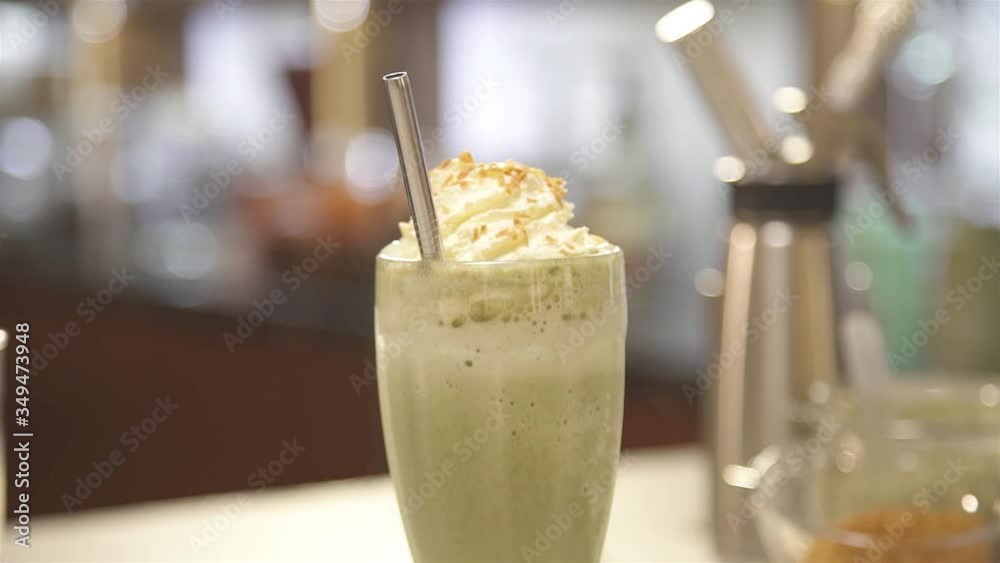 A drink with straw and whipped cream on top - slide left A drink with straw and whipped cream on top - slide left