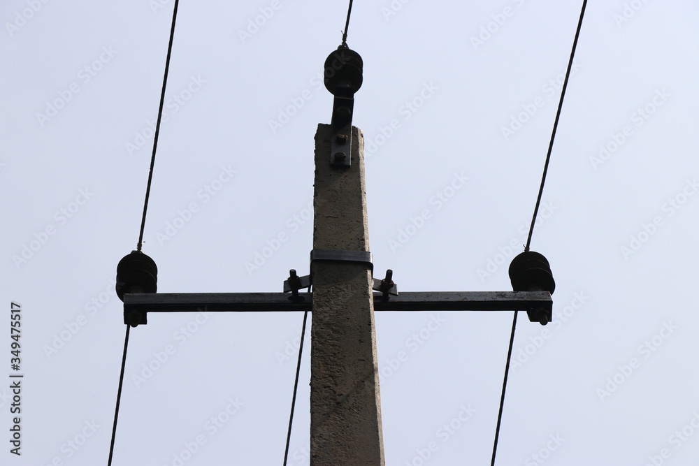 Electric pole made of concrete carrying 3 wires which gives current supply for homes Electric pole made of concrete carrying 3 wires which gives current supply for homes