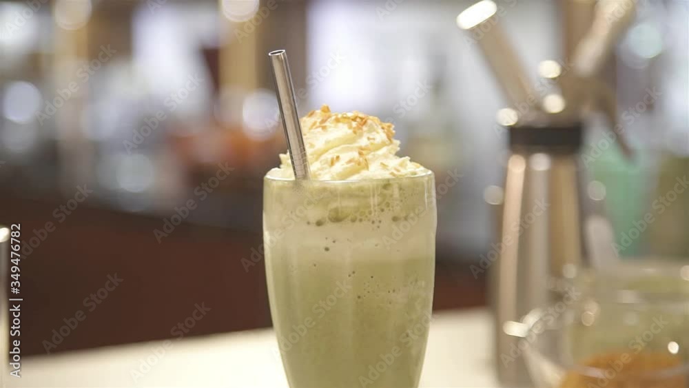 Metal straw inside of smoothie with cream - rack focus Metal straw inside of smoothie with cream - rack focus