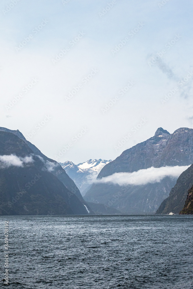 Majestic peaks among the clouds. FiordLand National Park. New Zealand