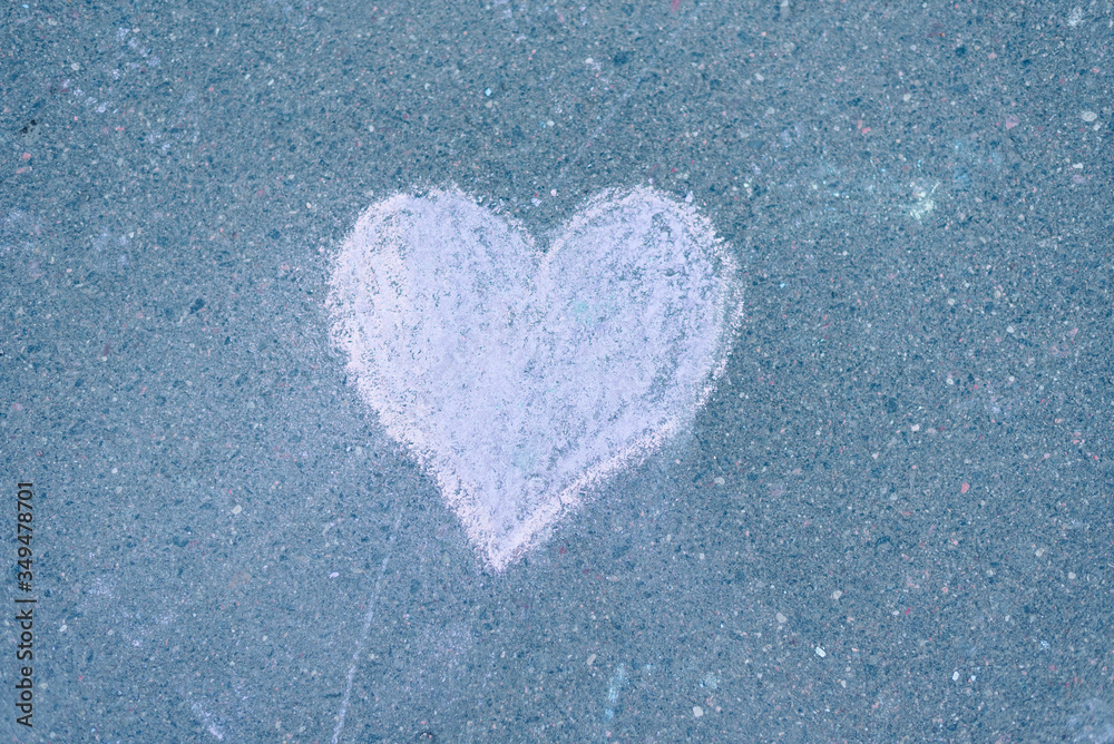 a heart drawn in chalk on the asphalt