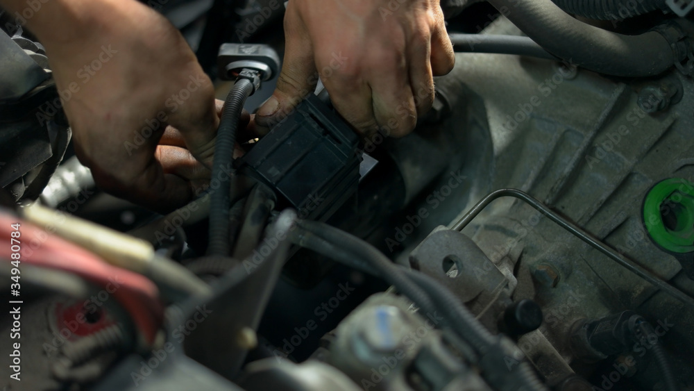 Repairman hands screwing car enging details. Close dirty male hands of a car service worker. Repairman hands screwing car enging details. Close dirty male hands of a car service worker.