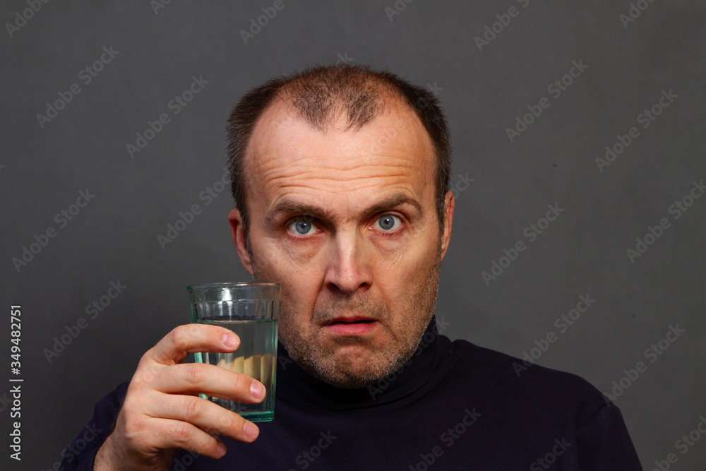 A frightened man opened his mouth in surprise.
Frightened face with bulging eyes due to fear. Angry man in dark clothes on a dark background. A frightened man opened his mouth in surprise.
Frightened face with bulging eyes due to fear. Angry man in dark clothes on a dark background.