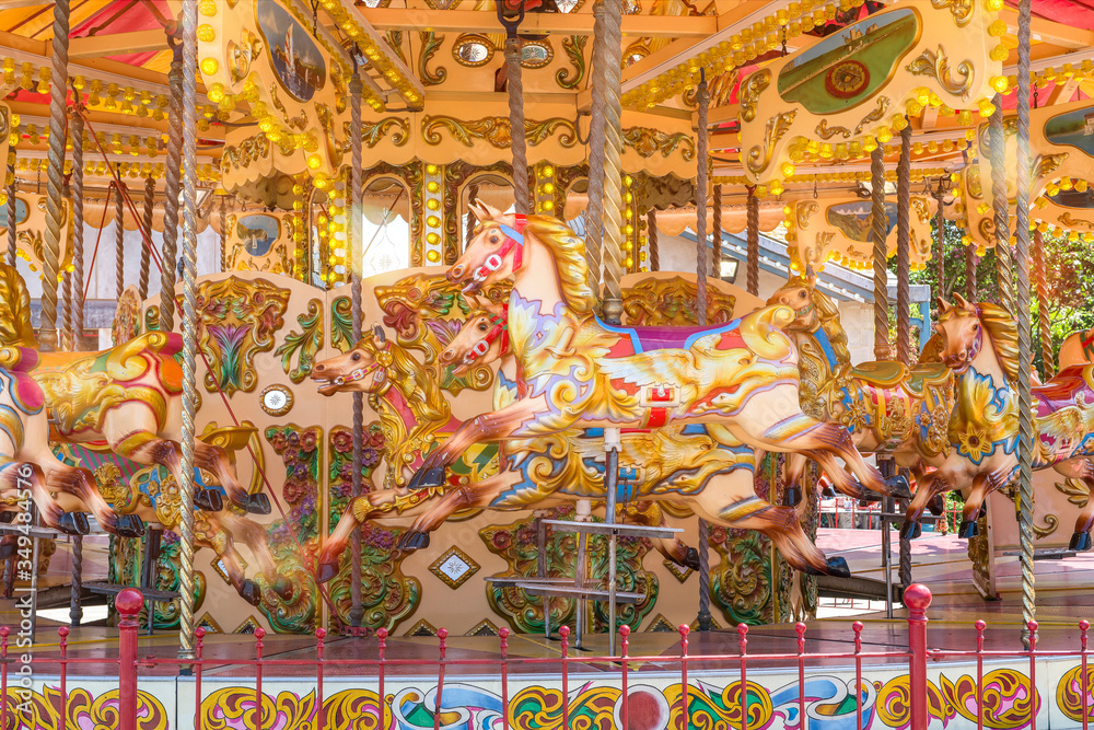 Close-up of a colorful carousel with horses to make a merry go round ride