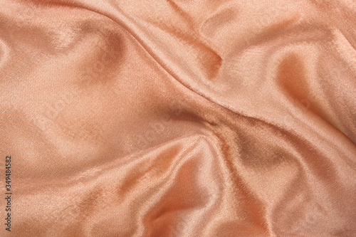 brown gold satin fabric texture curve background, soft focus.